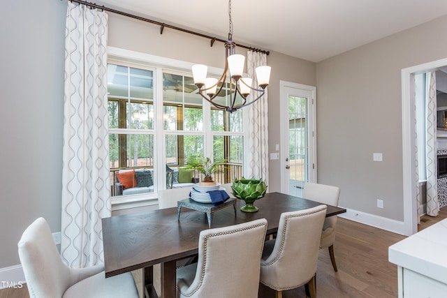 1412 Auman Rd, Raleigh, NC 27603 - dining space with a chandelier, dark wood-style floors, and baseboards