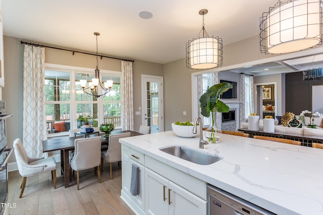 1412 Auman Rd, Raleigh, NC 27603 - kitchen featuring a sink, a chandelier, light wood-style floors, stainless steel appliances, and hanging light fixtures