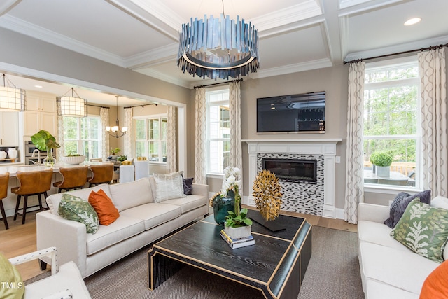 1412 Auman Rd, Raleigh, NC 27603 - living area featuring a chandelier, wood finished floors, a tile fireplace, crown molding, and beam ceiling