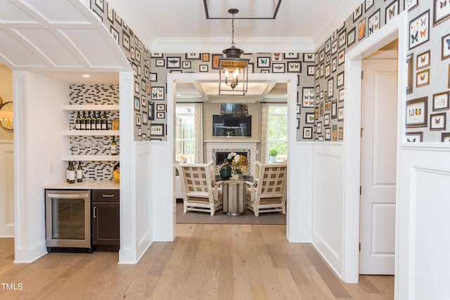 1412 Auman Rd, Raleigh, NC 27603 - corridor featuring beverage cooler, wallpapered walls, crown molding, light wood finished floors, and a wainscoted wall