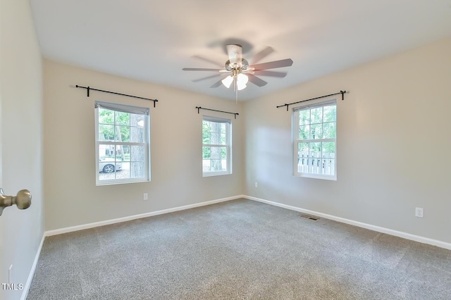 unfurnished room with ceiling fan, carpet, and baseboards