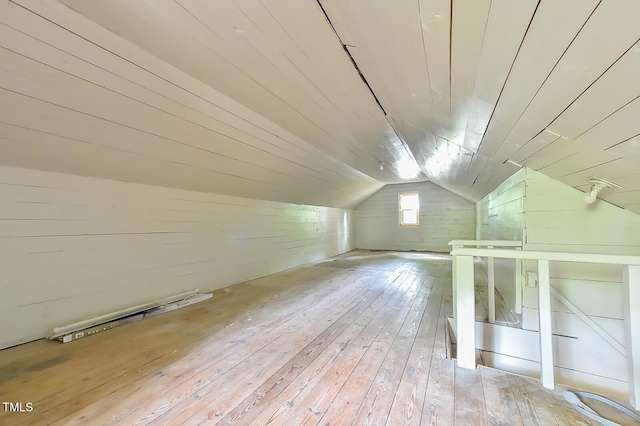 bonus room with wooden walls, hardwood / wood-style floors, lofted ceiling, and wood ceiling