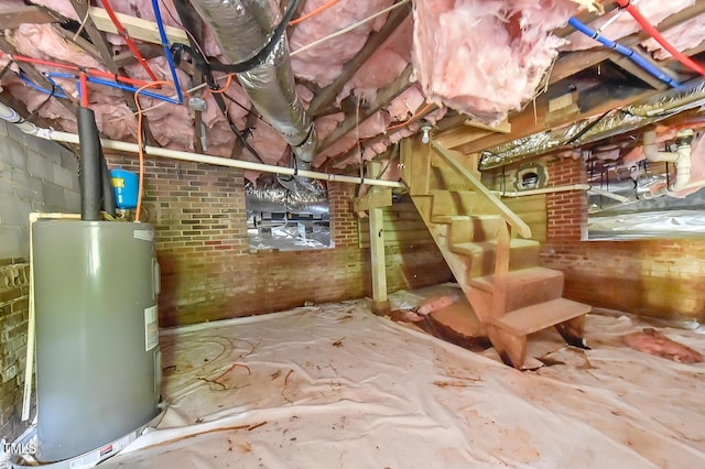 unfinished below grade area featuring water heater and stairway