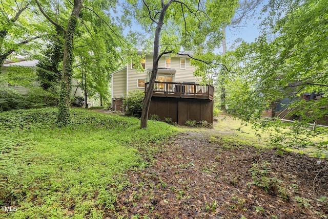 rear view of property featuring a wooden deck