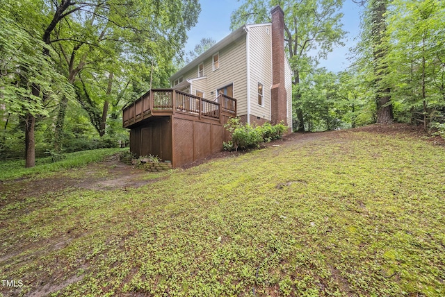 view of grassy yard with a wooden deck