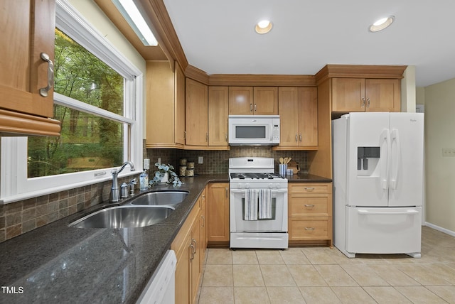 kitchen featuring white appliances, a sink, tasteful backsplash, light tile patterned floors, and recessed lighting