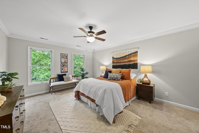 carpeted bedroom with ornamental molding, baseboards, and a ceiling fan
