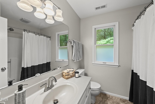 full bath with plenty of natural light, toilet, baseboards, and vanity