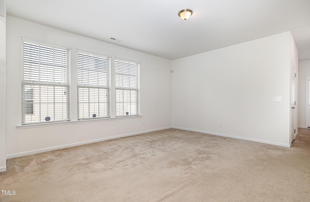 carpeted spare room with baseboards
