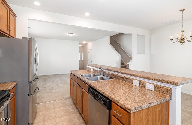 kitchen with stainless steel appliances, a sink, brown cabinets, a kitchen island with sink, and recessed lighting