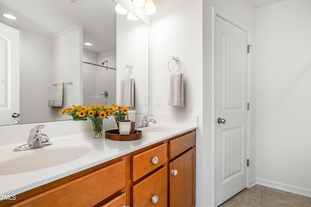 full bathroom featuring tile patterned flooring, double vanity, a shower, recessed lighting, and baseboards