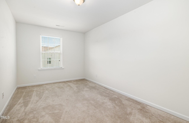carpeted spare room with baseboards