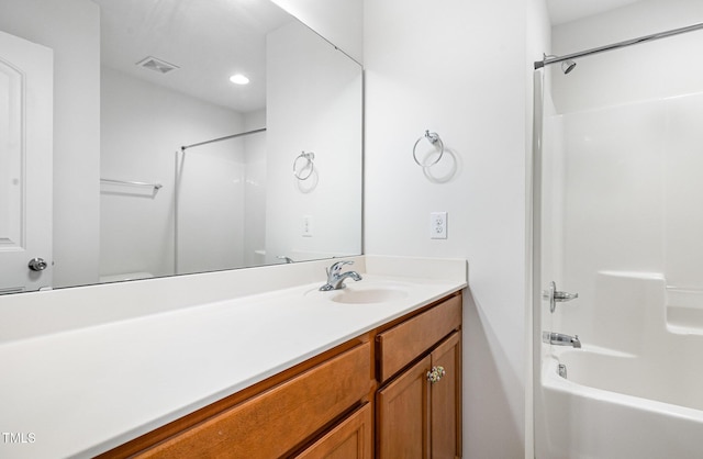 full bath featuring vanity, bathing tub / shower combination, and recessed lighting