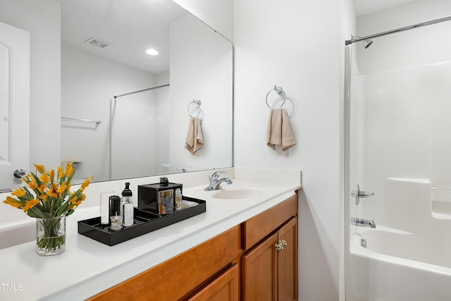 full bathroom featuring double vanity, recessed lighting, and bathing tub / shower combination