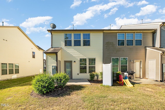 back of property featuring a patio and a lawn