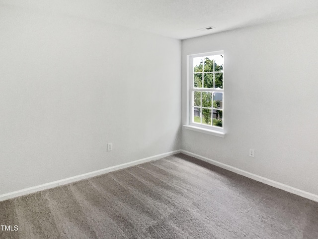 spare room with carpet flooring and baseboards