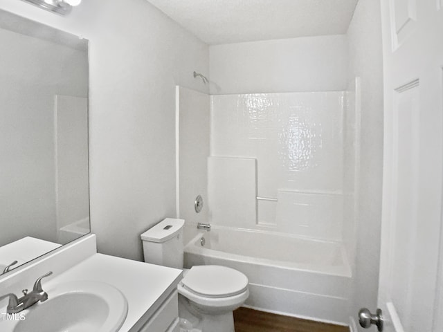 bathroom featuring toilet, bathtub / shower combination, vanity, and wood finished floors