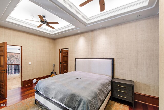 6510 New Market Way, Raleigh, NC 27615 - bedroom with wood finished floors, a raised ceiling, and a ceiling fan