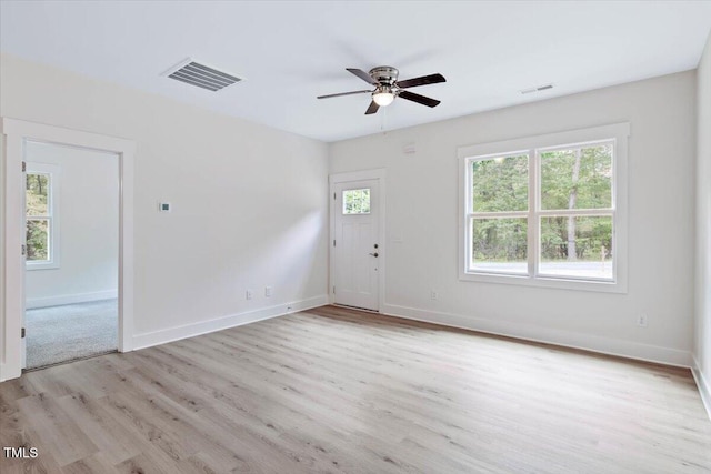 entryway with wood finished floors, a ceiling fan, and baseboards