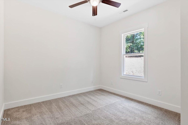 unfurnished room featuring light colored carpet, baseboards, and ceiling fan