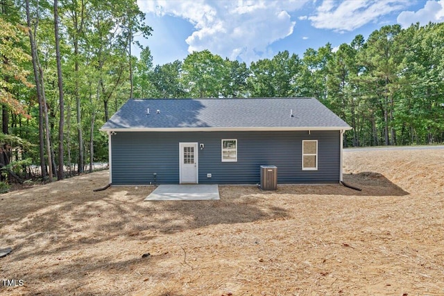 back of property with central air condition unit and a patio area