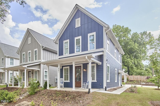 941 W Club Blvd, Durham, NC 27701 - view of front of home featuring board and batten siding, covered porch, and a front yard