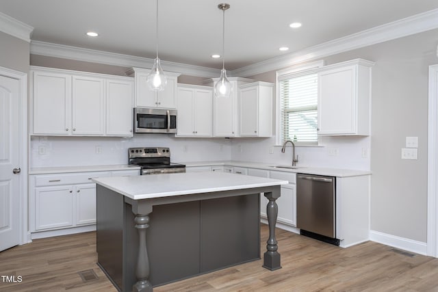453 Granite Saddle Dr, Rolesville, NC 27571 - kitchen with appliances with stainless steel finishes, light countertops, white cabinets, a kitchen island, and a sink