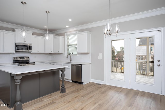 453 Granite Saddle Dr, Rolesville, NC 27571 - kitchen featuring stainless steel appliances, light countertops, ornamental molding, decorative backsplash, and light wood-type flooring