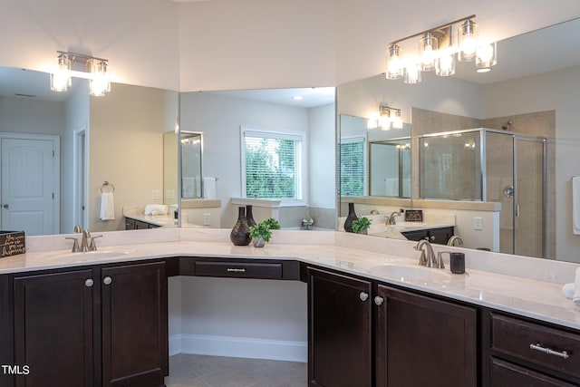 453 Granite Saddle Dr, Rolesville, NC 27571 - bathroom with a stall shower, two vanities, and tile patterned floors
