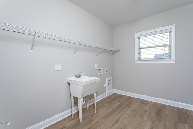453 Granite Saddle Dr, Rolesville, NC 27571 - laundry room with electric dryer hookup, hookup for a washing machine, gas dryer hookup, light wood-style flooring, and baseboards