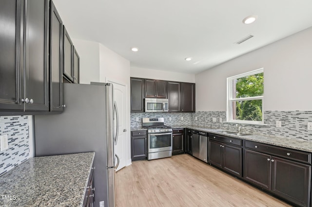 1534 Glenwater Dr, Cary, NC 27519 - kitchen featuring stainless steel appliances, a sink, backsplash, and recessed lighting