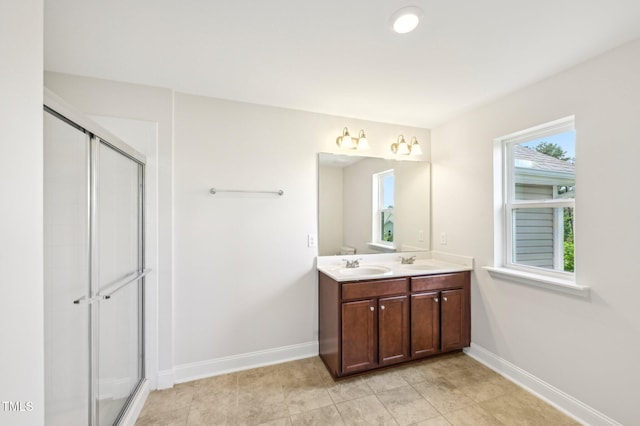 1534 Glenwater Dr, Cary, NC 27519 - full bathroom with double vanity, baseboards, and an enclosed shower