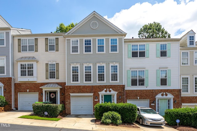 7244 Galon Glen Rd, Raleigh, NC 27613 - townhome / multi-family property featuring brick siding, an attached garage, and driveway