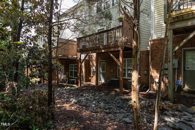 7244 Galon Glen Rd, Raleigh, NC 27613 - rear view of property featuring brick siding, a deck, and central AC