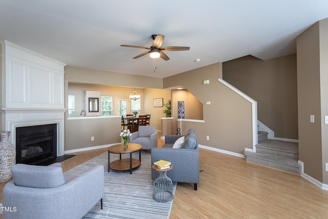 7244 Galon Glen Rd, Raleigh, NC 27613 - living room with stairs, ceiling fan, light wood-style flooring, and baseboards