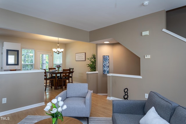 7244 Galon Glen Rd, Raleigh, NC 27613 - living area with a chandelier, light wood-type flooring, and baseboards