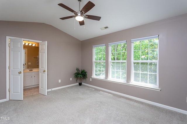 7244 Galon Glen Rd, Raleigh, NC 27613 - unfurnished room with vaulted ceiling, a ceiling fan, baseboards, light colored carpet, and healthy amount of natural light