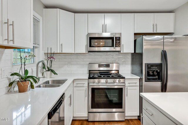 2200 Wyman Pl, Durham, NC 27707 - kitchen with stainless steel appliances, a sink, light countertops, and white cabinetry