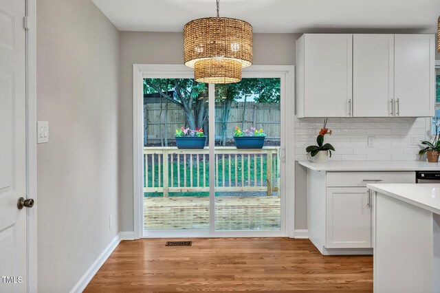 2200 Wyman Pl, Durham, NC 27707 - unfurnished dining area with a chandelier, light wood-style floors, and baseboards
