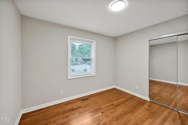 2200 Wyman Pl, Durham, NC 27707 - unfurnished bedroom with wood finished floors, a closet, and baseboards