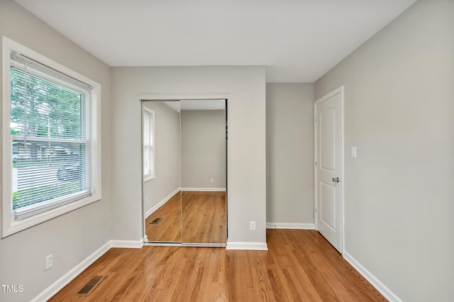 2200 Wyman Pl, Durham, NC 27707 - unfurnished bedroom with light wood-style flooring, baseboards, and a closet