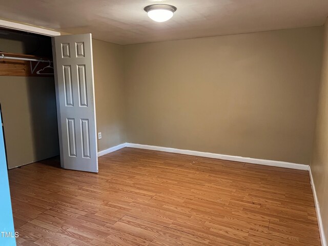 5932 Johnson Pond Rd, Fuquay Varina, NC 27526 - unfurnished bedroom with light wood finished floors and a closet