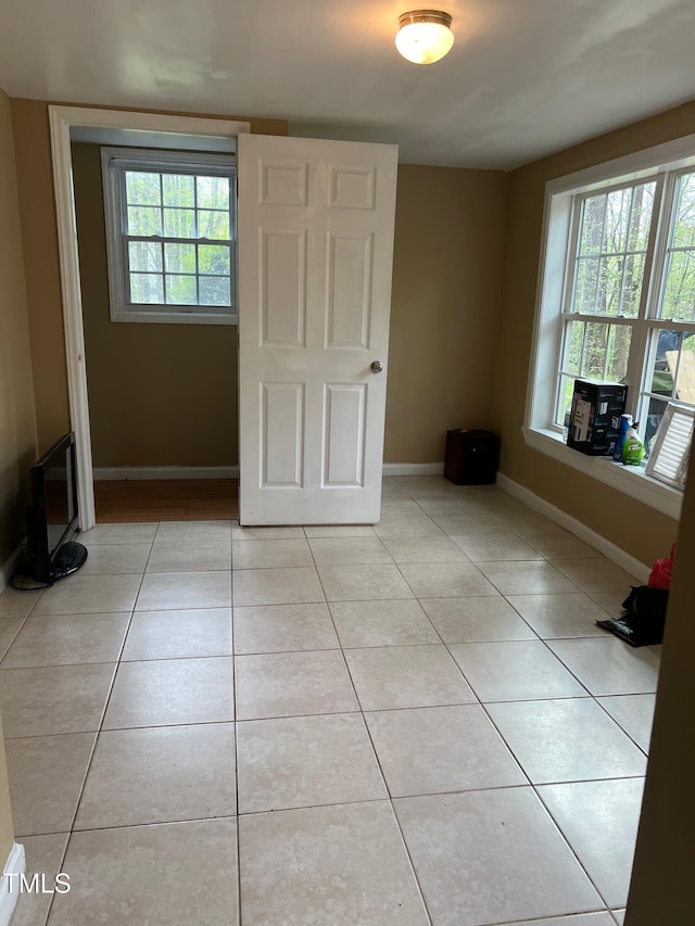 5932 Johnson Pond Rd, Fuquay Varina, NC 27526 - unfurnished bedroom featuring light tile patterned floors and multiple windows