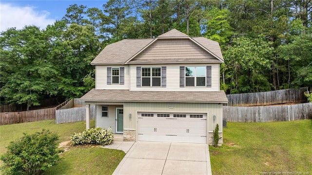 4572 Headwind Dr, Fayetteville, NC 28306 - view of front of property featuring driveway, a garage, roof with shingles, and stone siding