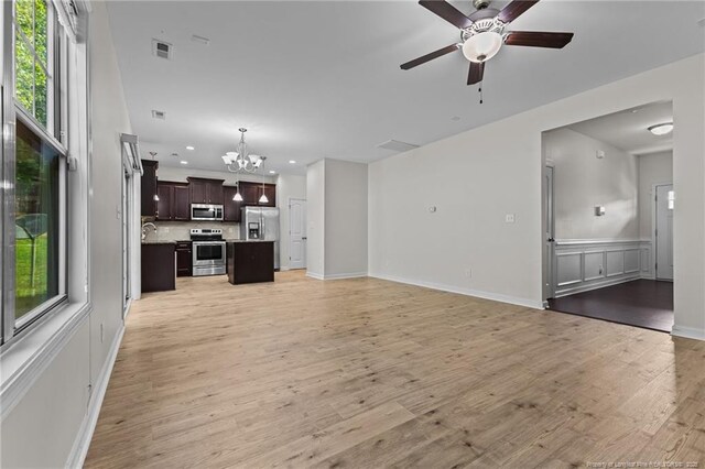 4572 Headwind Dr, Fayetteville, NC 28306 - unfurnished living room with a chandelier, a ceiling fan, plenty of natural light, recessed lighting, and light wood-type flooring