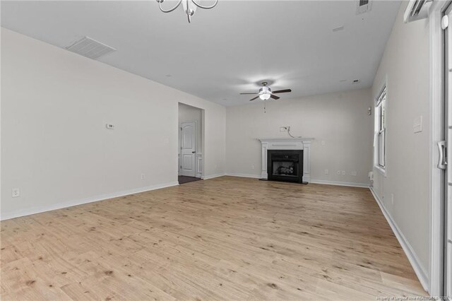 4572 Headwind Dr, Fayetteville, NC 28306 - unfurnished living room with light wood-style floors, a ceiling fan, a fireplace, and baseboards