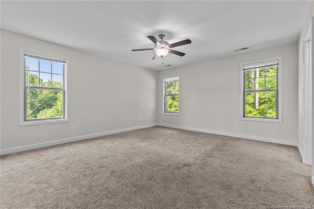 4572 Headwind Dr, Fayetteville, NC 28306 - carpeted empty room featuring healthy amount of natural light, a ceiling fan, and baseboards