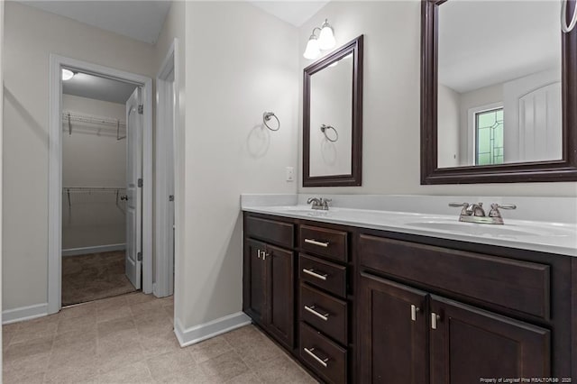 4572 Headwind Dr, Fayetteville, NC 28306 - full bathroom with baseboards, double vanity, and a spacious closet
