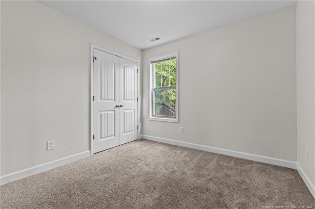 4572 Headwind Dr, Fayetteville, NC 28306 - unfurnished bedroom featuring carpet floors, baseboards, and a closet