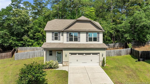 4572 Headwind Dr, Fayetteville, NC 28306 - craftsman-style house featuring a garage, concrete driveway, stone siding, and a shingled roof